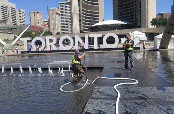 The City of Toronto's Nathan Phillips Square fountain being vacuumed by Fountain Place Companies water fountain maintenance technicians. This vacuuming allows for debris removal and and a beautiful fountain for everyone to enjoy.