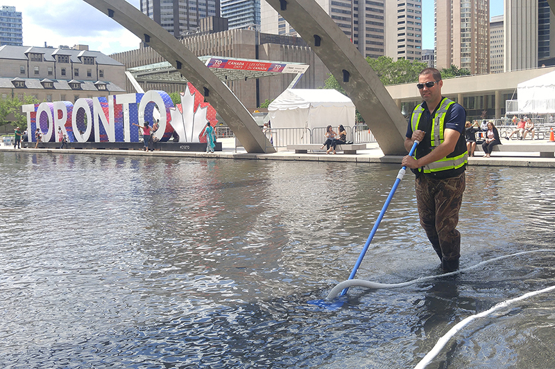 Fountain Place technicians servicing the Nathan Phillips Square fountain for the City of Toronto
