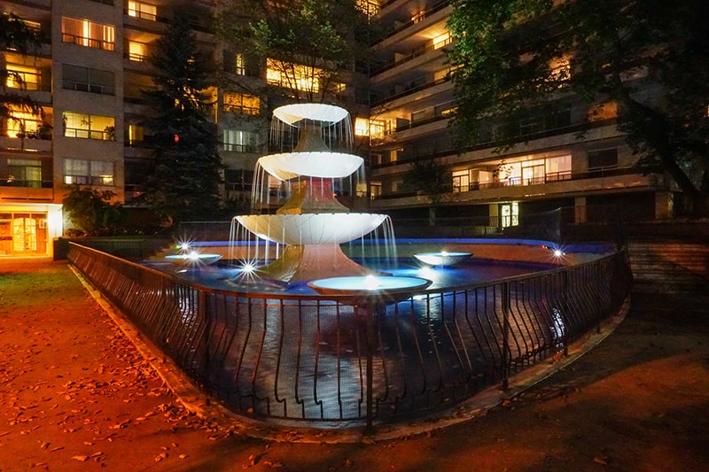 Historic Toronto courtyard fountain at night after its lighting system was restored