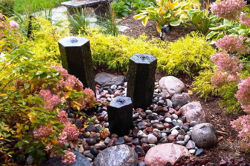 Backyard pond with basalt column bubbling rocks in Toronto
