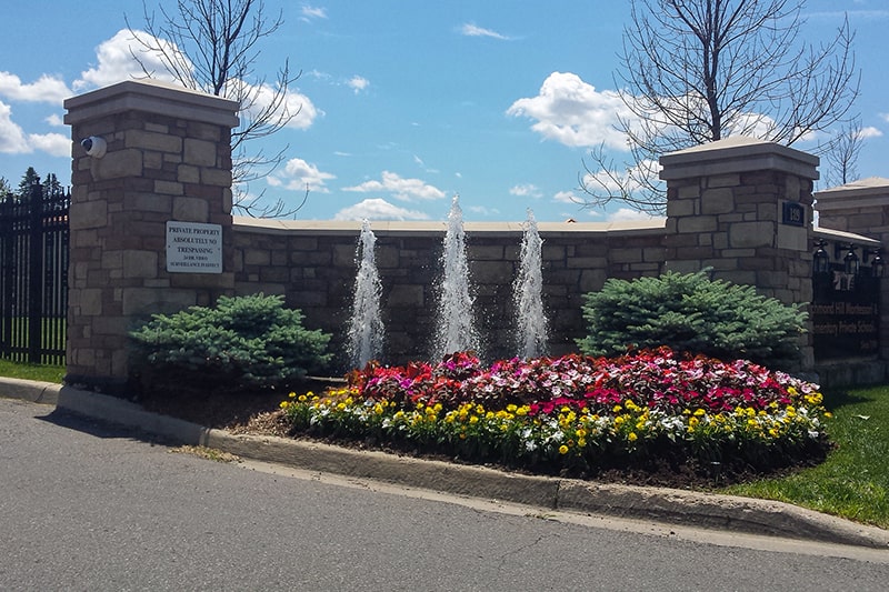 Commercial garden fountain with vertical jets and flower beds