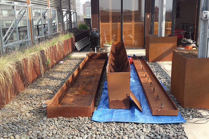 Corten steel fountain trough opened up for repair and resealing