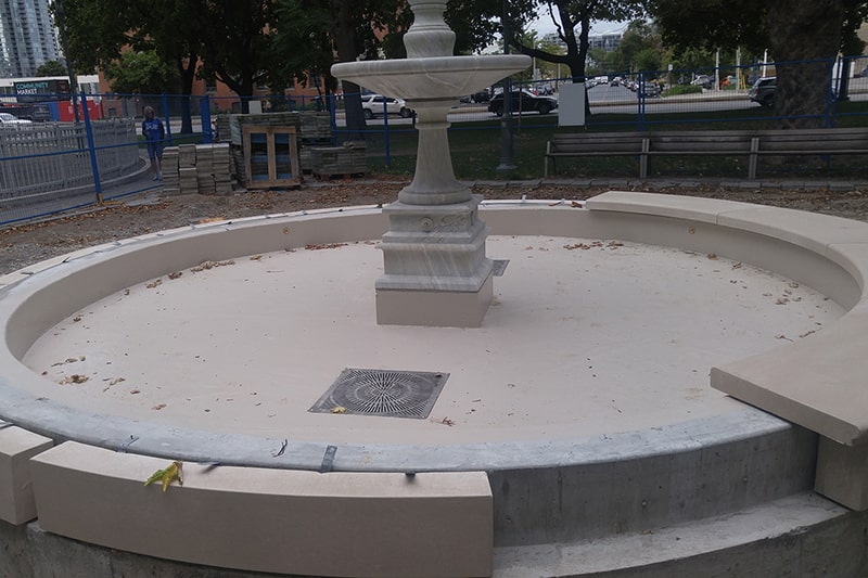 Decorative coping around the new Clarence Square fountain basin in Toronto