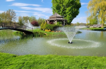 Two Aqua Control floatikng fountains can be seen here, a smaller 0.5hp Evolution series is located in front of the bridge while a larger 5.0hp Aqua Control Pentalator fountain is located behind the island