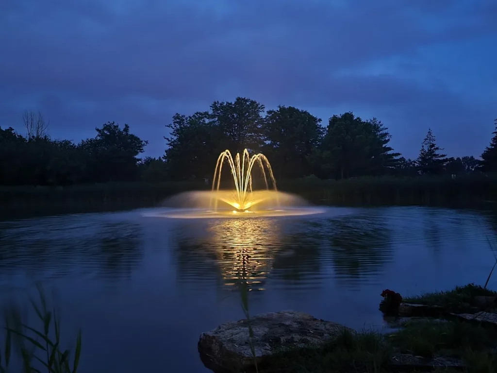 Floating fountain lit at dusk at Elgin Mills, Richmond Hill