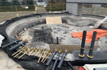Using specialized bronze fountain slab penetrations and fittings a hole was broken through the parking garage slab to allow for the installation of pipes and electrical conduits.