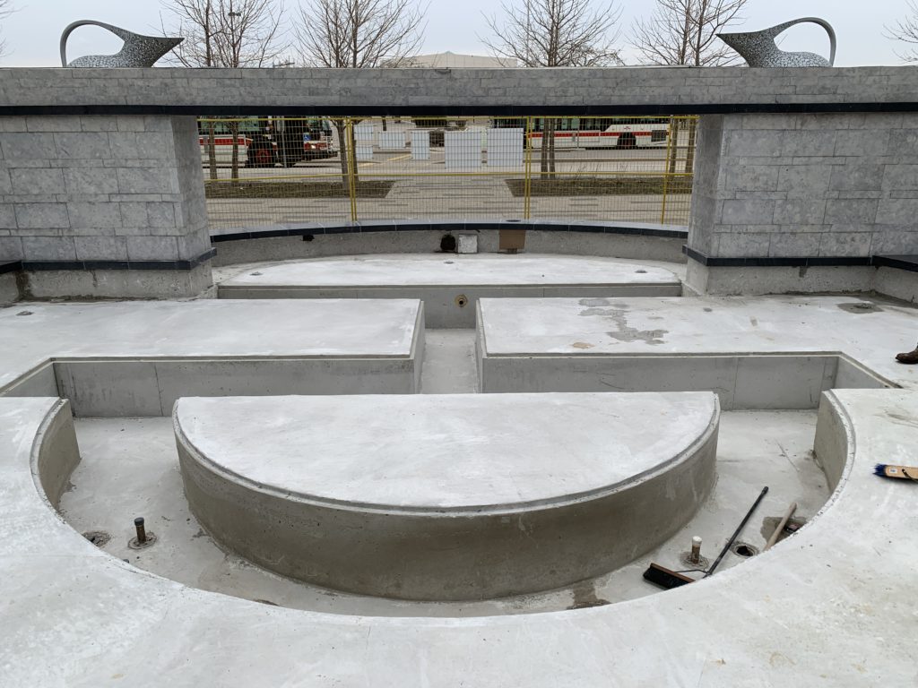 New fountain basin with its half-moon bench wall before waterproofing