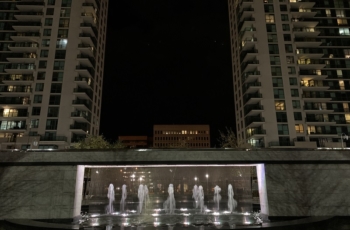 This image shows the water fountains submersible LED lights in full effect and highlighted between two buildings.