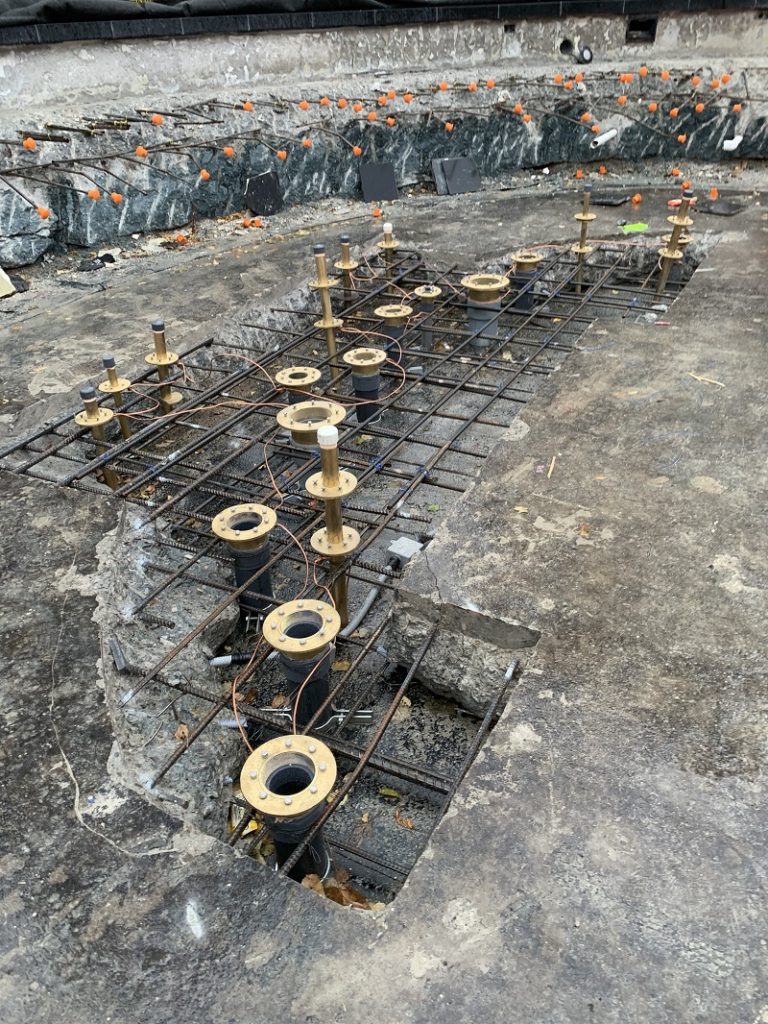 Opening cut through the structural slab to bring pipes into the new mechanical area
